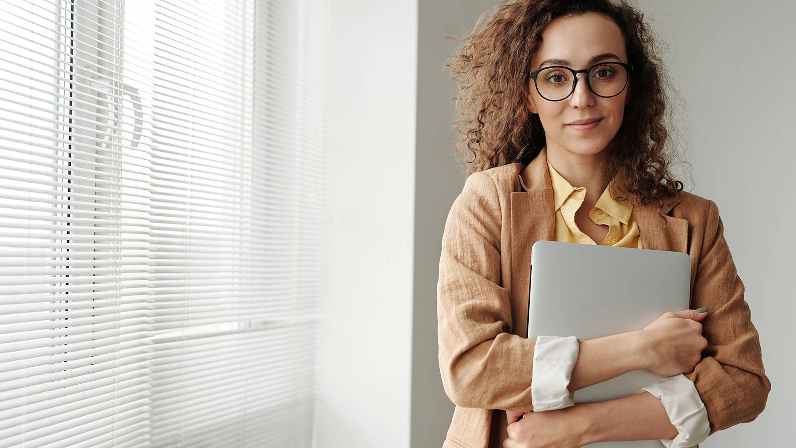 A professional holding a client file in a bright office